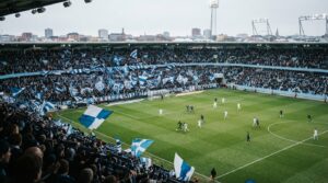 Fotbollsstadion fylld med supportrar under ett intensivt derby i svensk fotboll