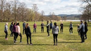 Människor tränar tillsammans utomhus i en svensk park för att främja psykisk hälsa